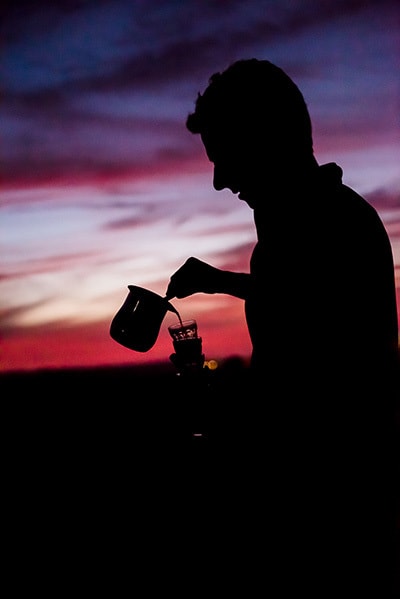 A man pouring tea at sunset during a tour in Israel