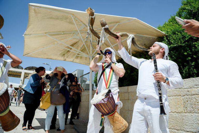 Street musicians playing shofars in Israel.