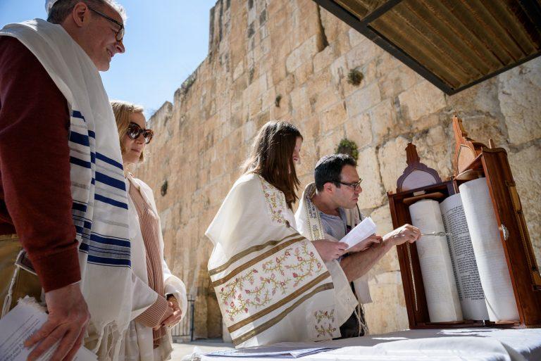 A young girl and a rabbi at a bat mitzvah in Israel.