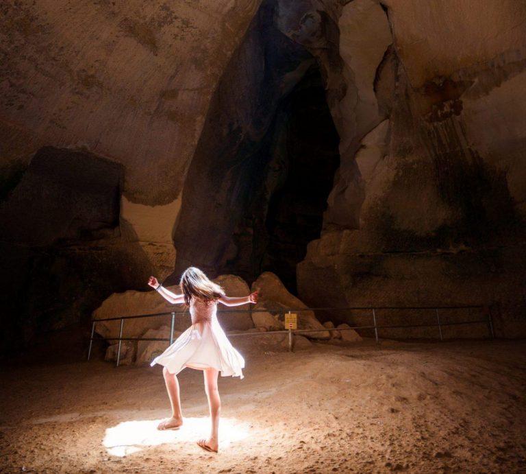 Girl dancing in a cave