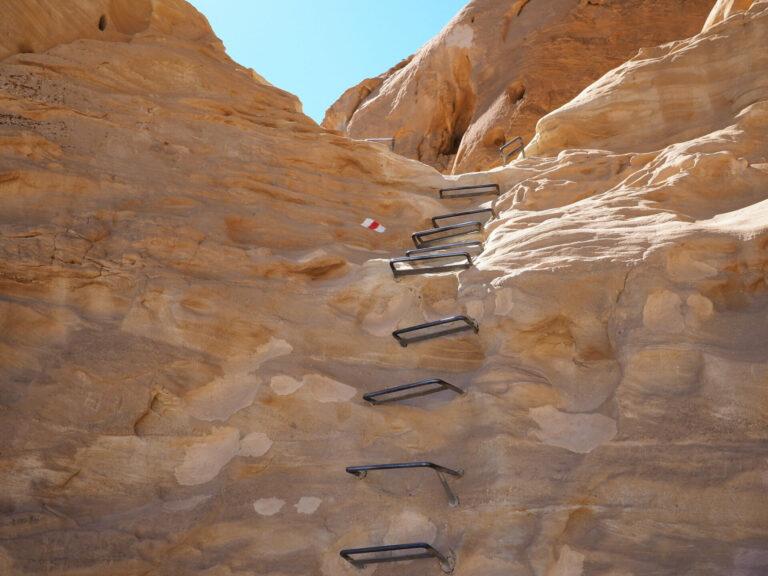 Metal stairs leading up a rock face in the Negev Desert.